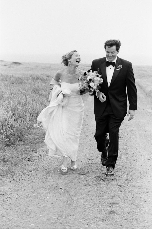Happy couple walking down road - wedding photo by top Austin based wedding photographers Q Weddings